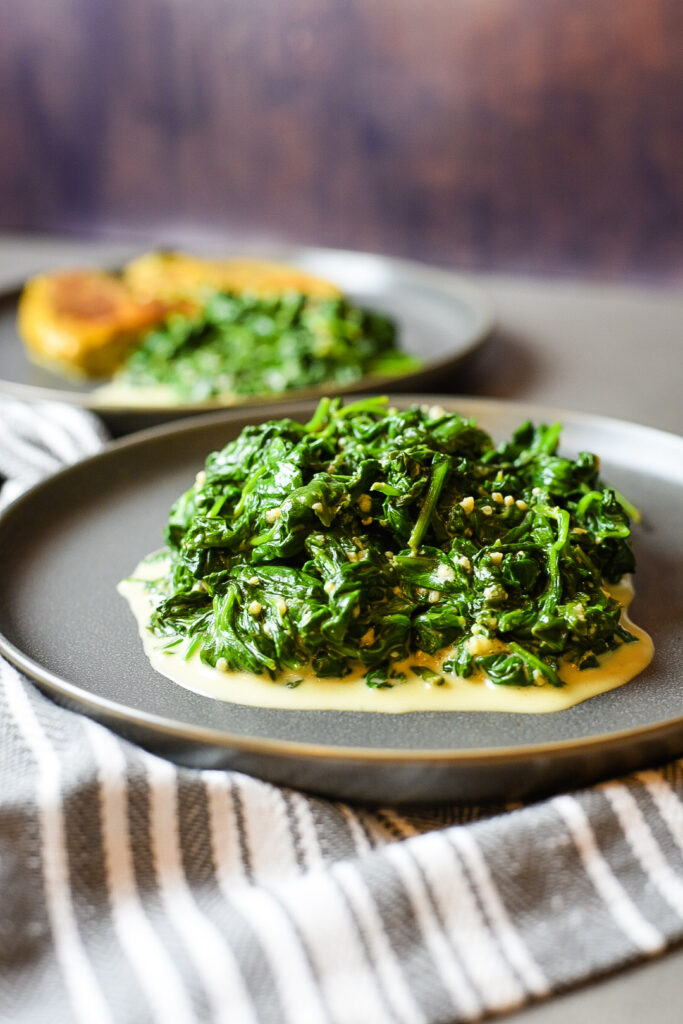 A serving of creamed spinach on a plate. 