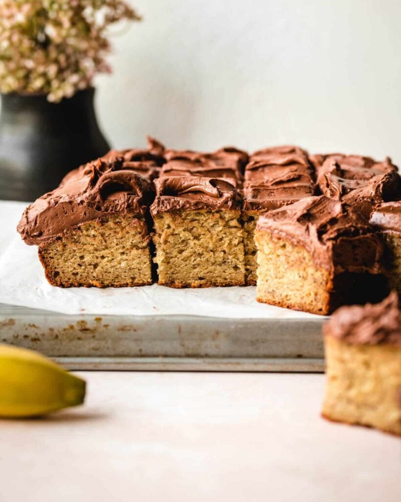 Banana cake with chocolate frosting cut into snack sized squares. 