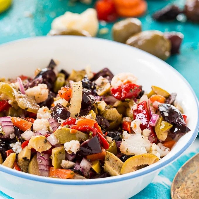 White serving bowl with olive salad in it. 