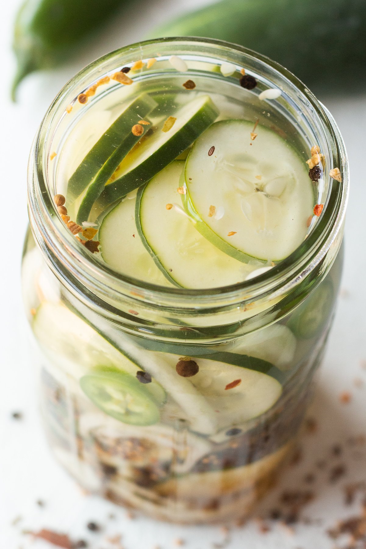 Refrigerator pickles in a mason jar with spices.