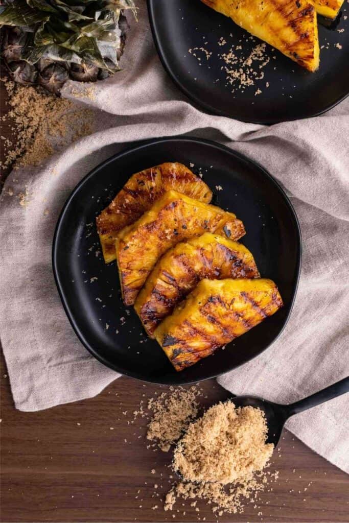 Slices of brown sugar grilled pineapple on a plate. 