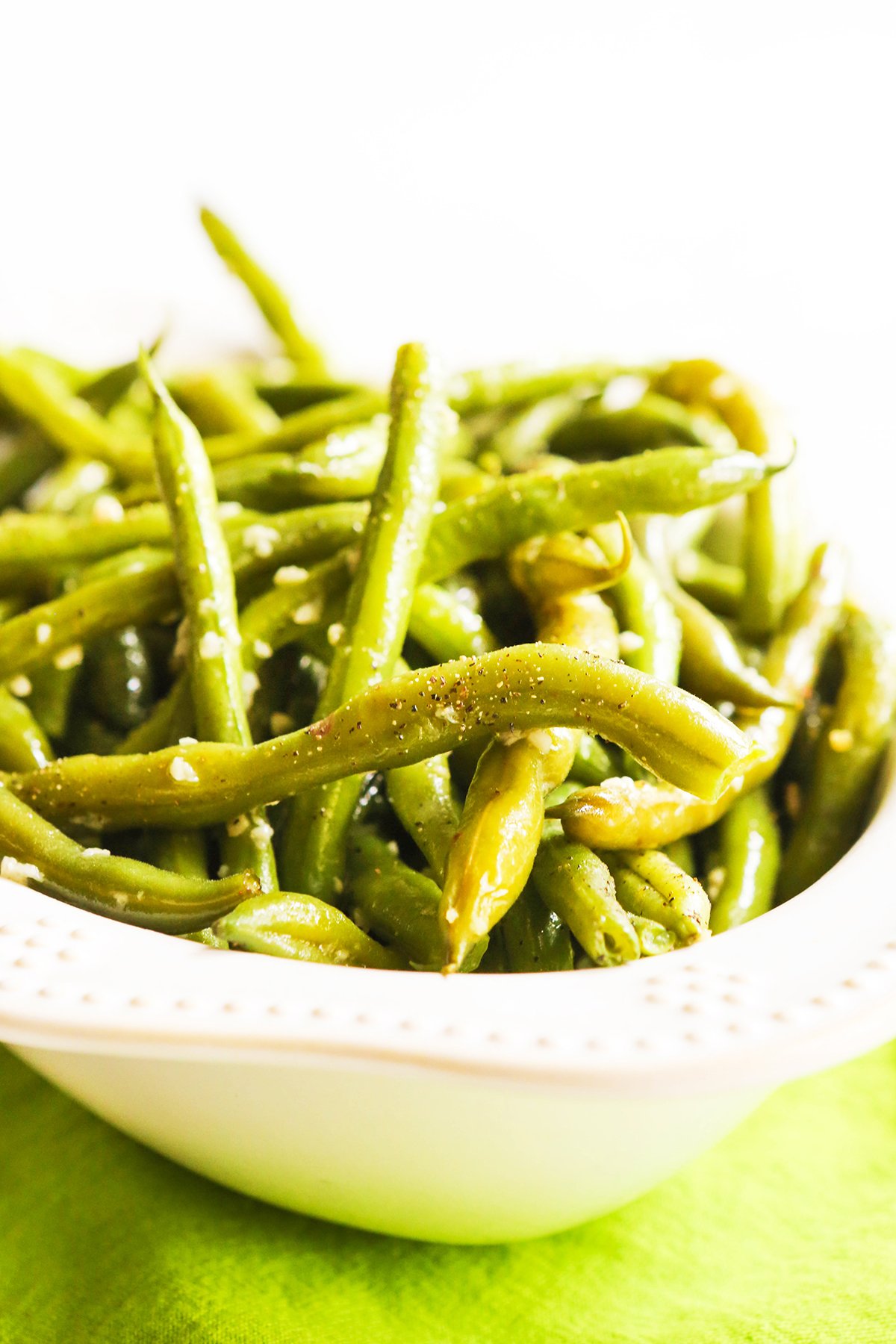 Bowl of cooked instant pot green beans with pepper over top.