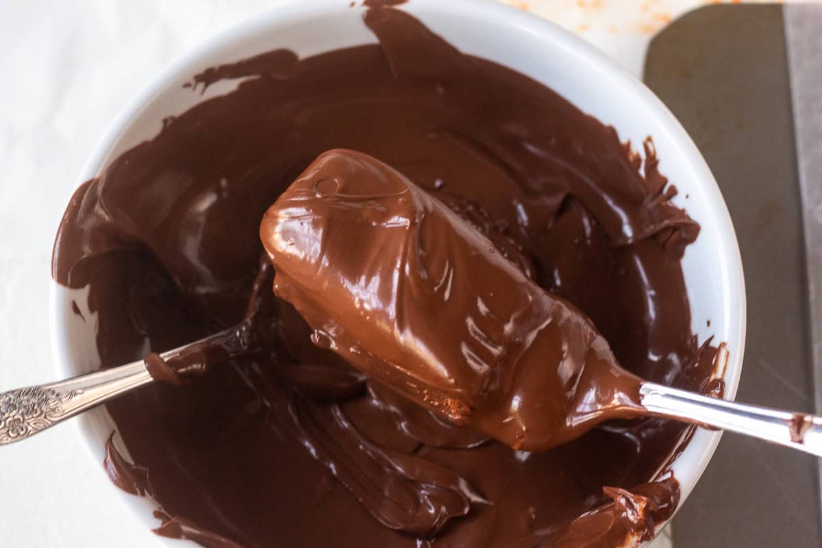 Chocolate coating on a Butterfinger candy bar in a white bowl.