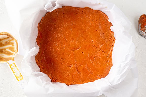 Close-up of homemade Butterfingers candy base in parchment paper.