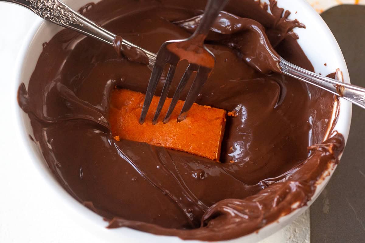 Chocolate-covered homemade Butterfingers with a piece on a fork.