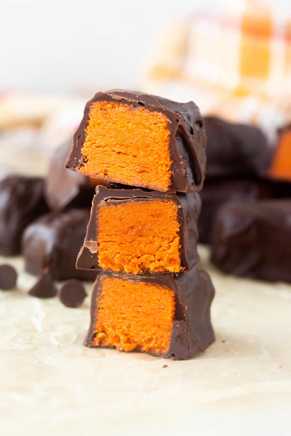 Stacked homemade Butterfingers with chocolate coating and orange interior.