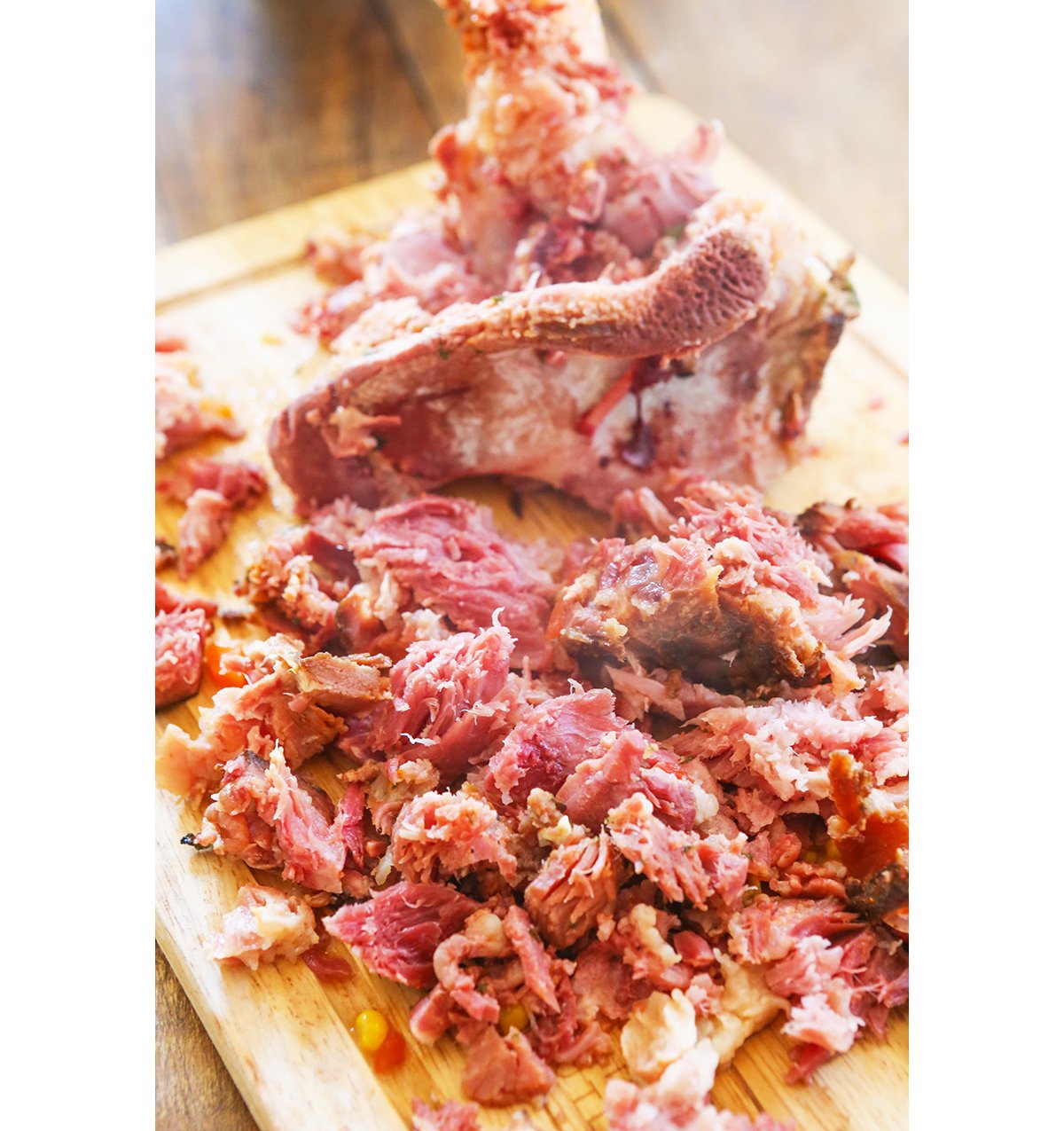 Ham bone on cutting board with meat removed.