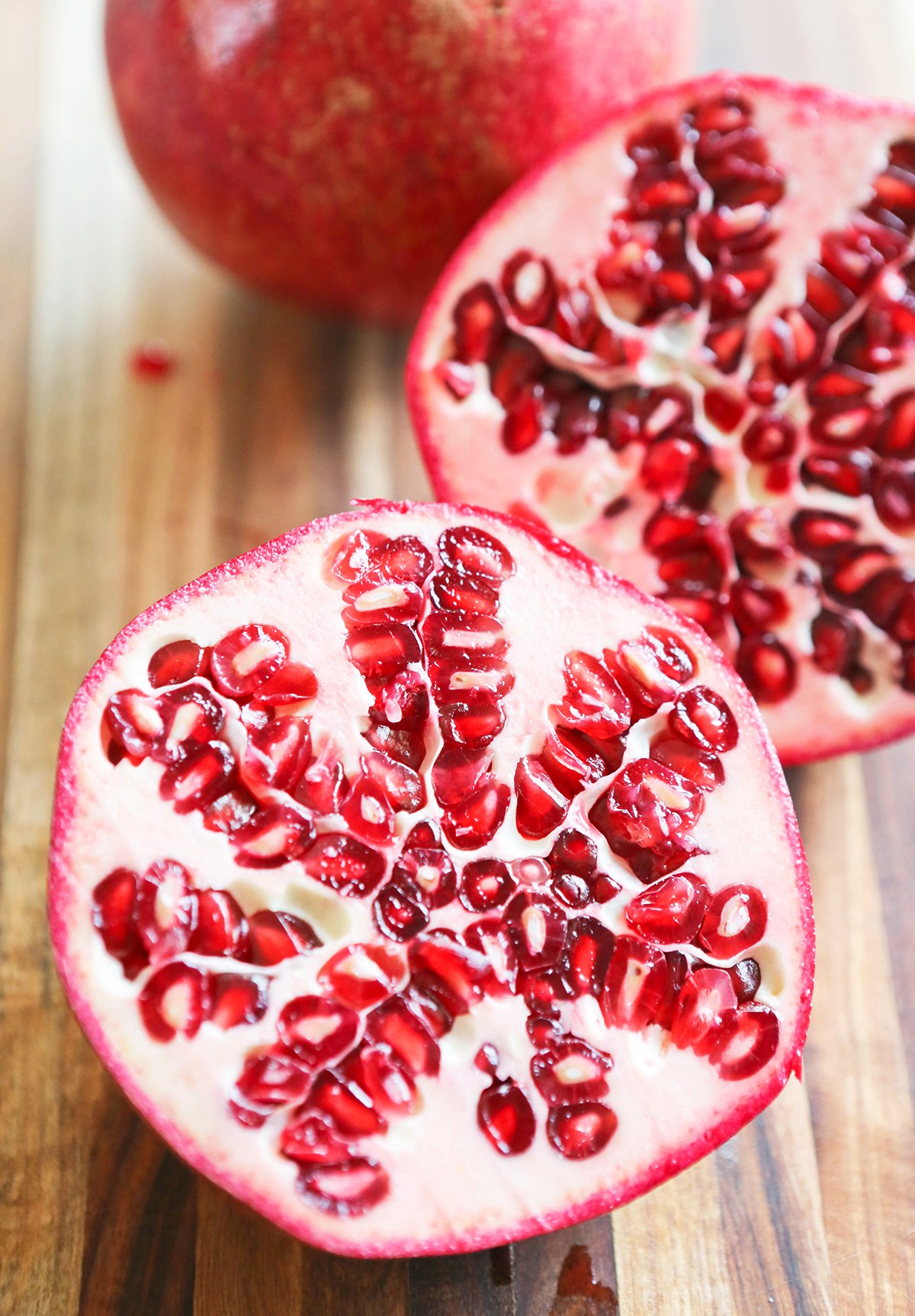 Close up of a pomegranate cut in half, exposing feeds.