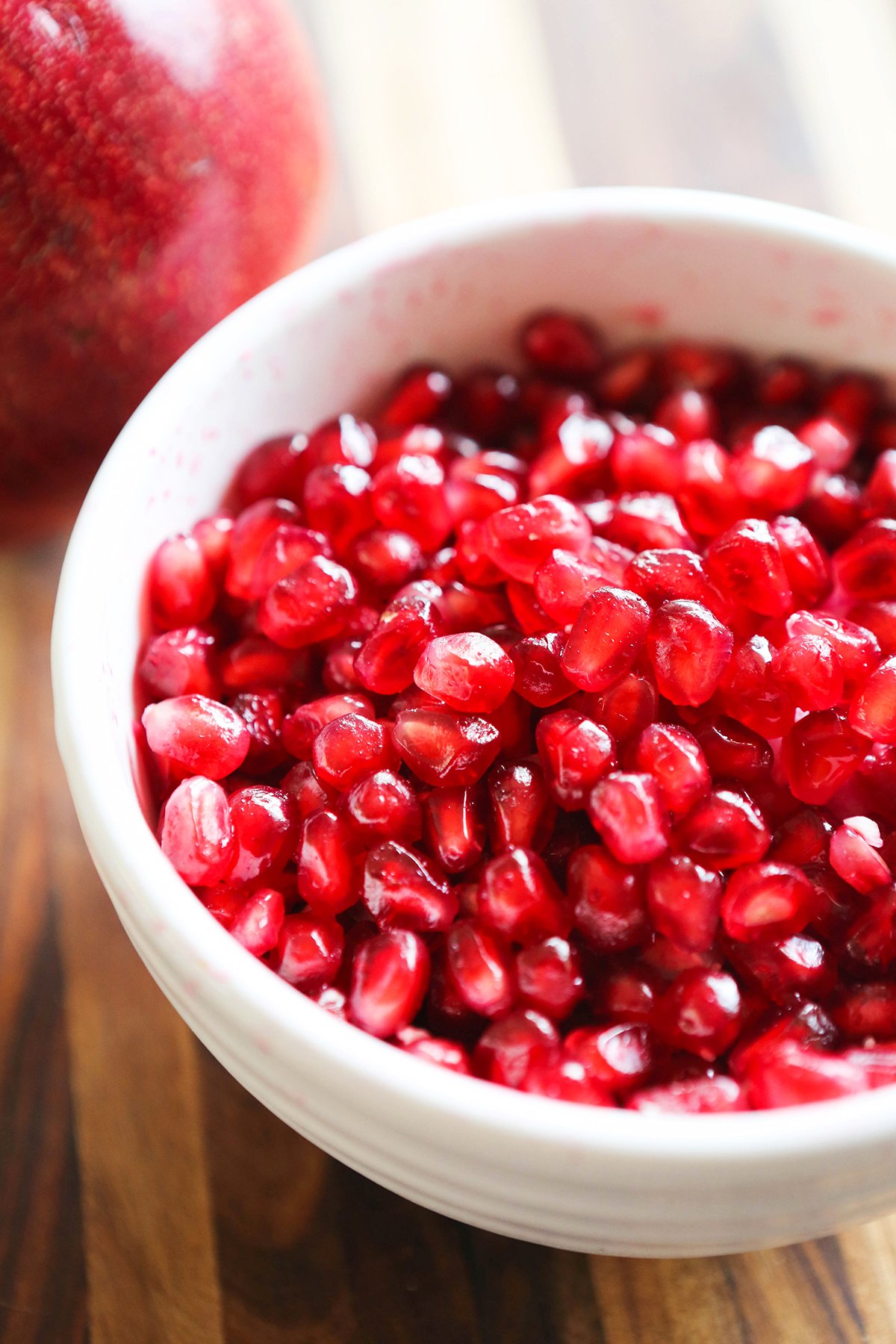 Bowl filled with red pomegranate seeds.
