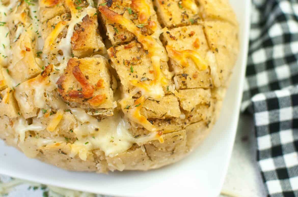 Garlic cheesy pull apart loaf on a plate. 