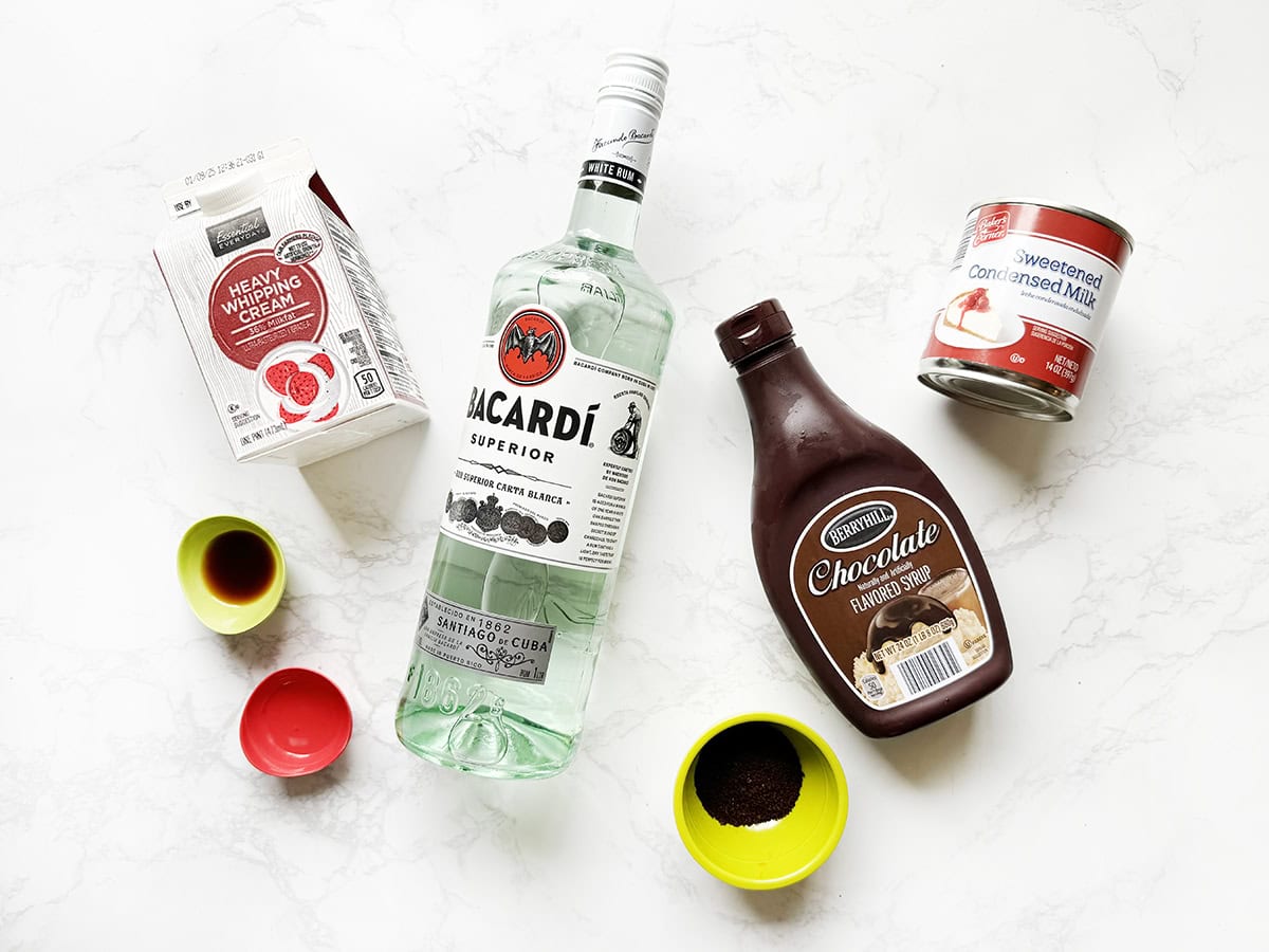 Ingredients for Homemade Baileys lined up on a white counter.