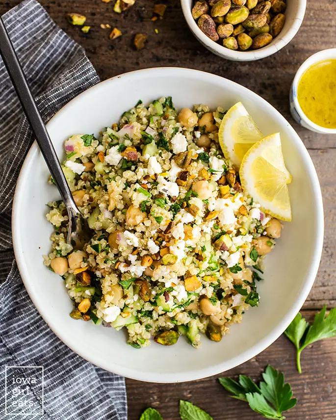 Jennifer Aniston salad in a bowl with lemon wedges. 