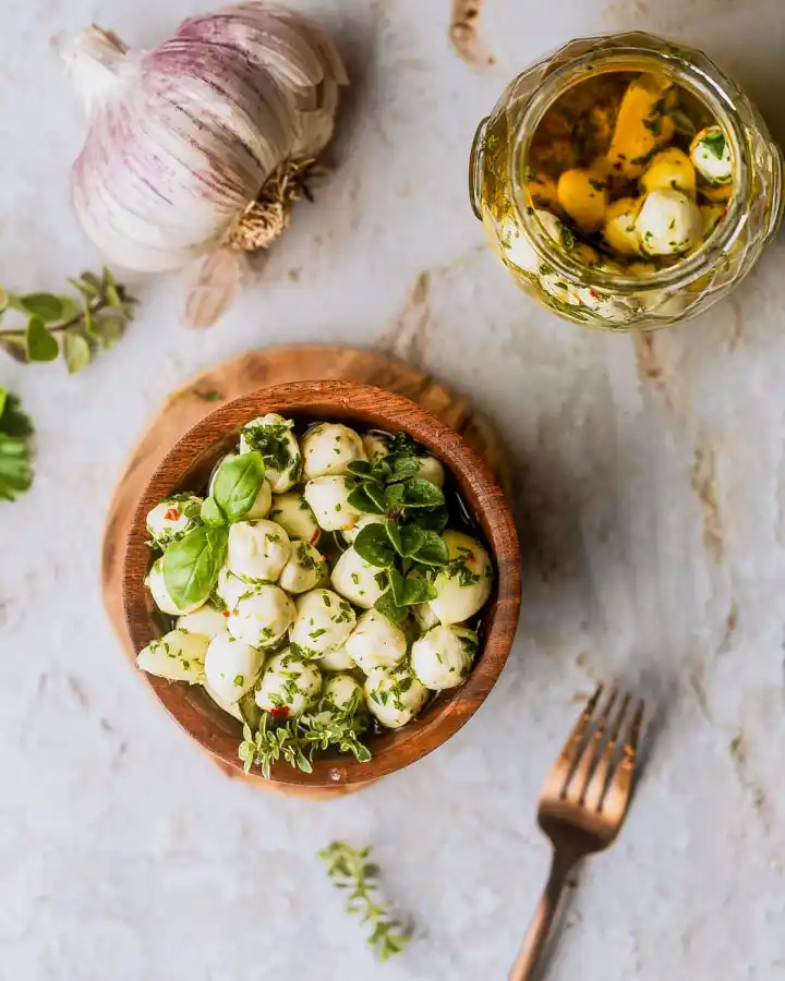 marinated mozzarella balls in a wooden bowl. 