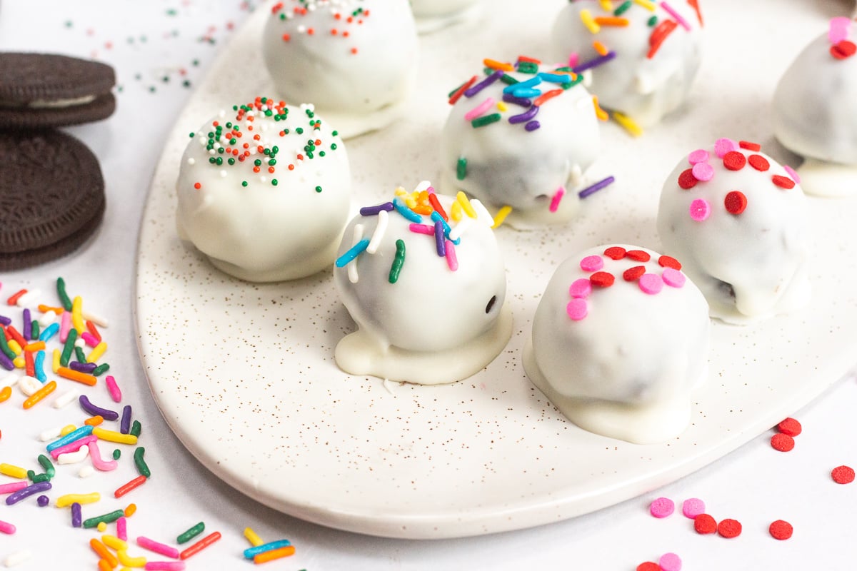 Colorful sprinkles on oreo balls, lined up on a serving platter.