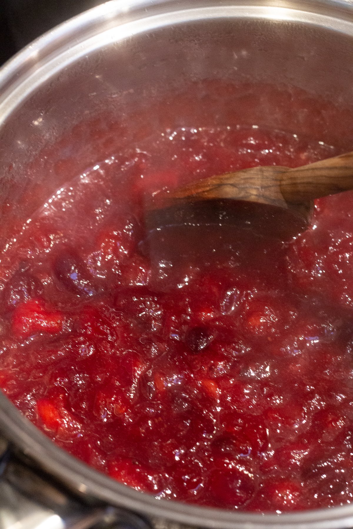 Cranberry sauce cooking in a saucepan.