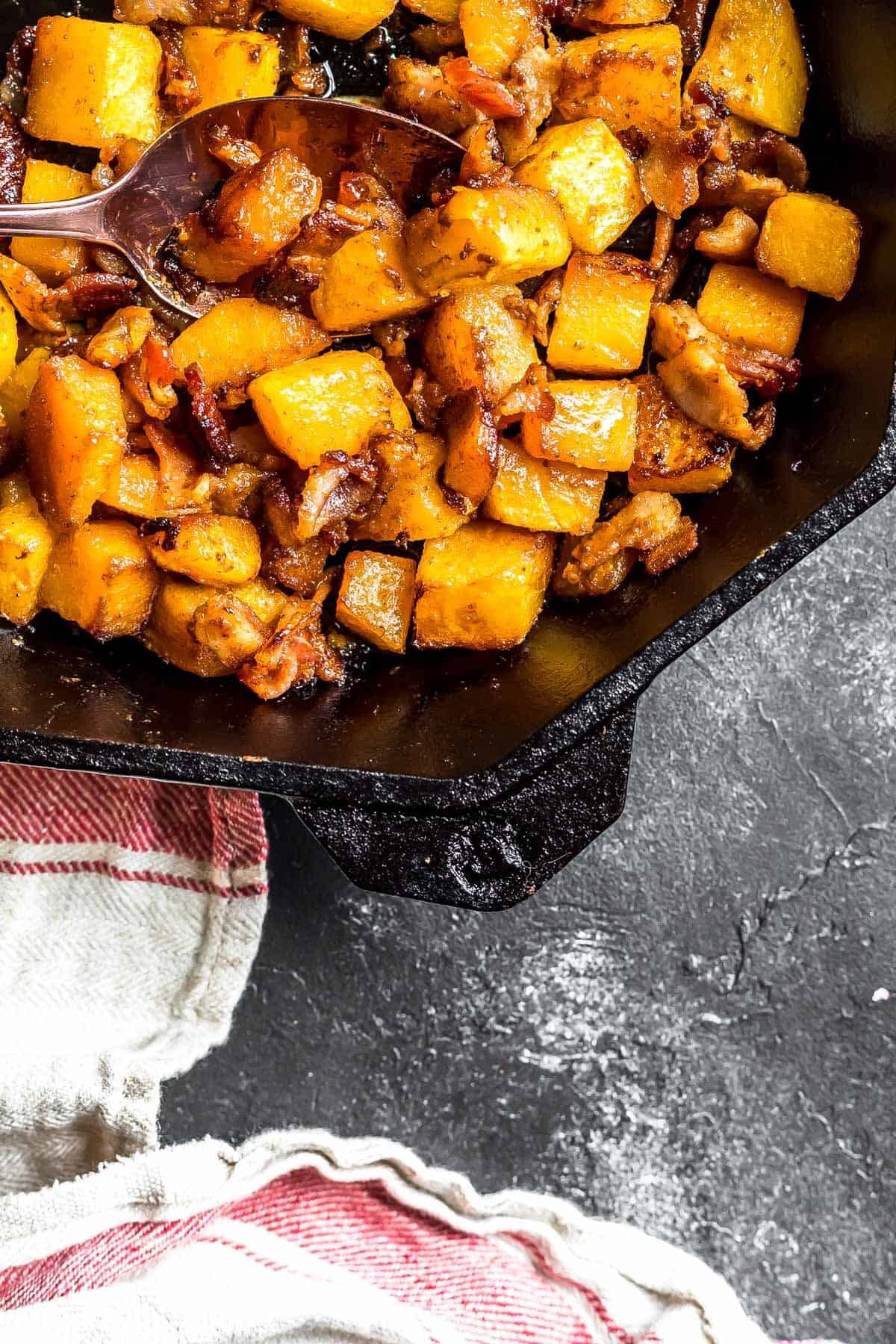 Grill dish filled with bacon roasted butternut squash. 
