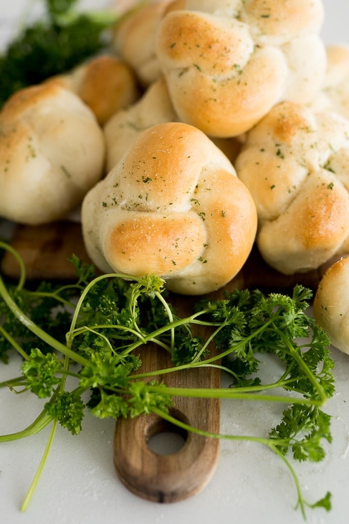 Garlic knots with a parsley garnish on the side. 