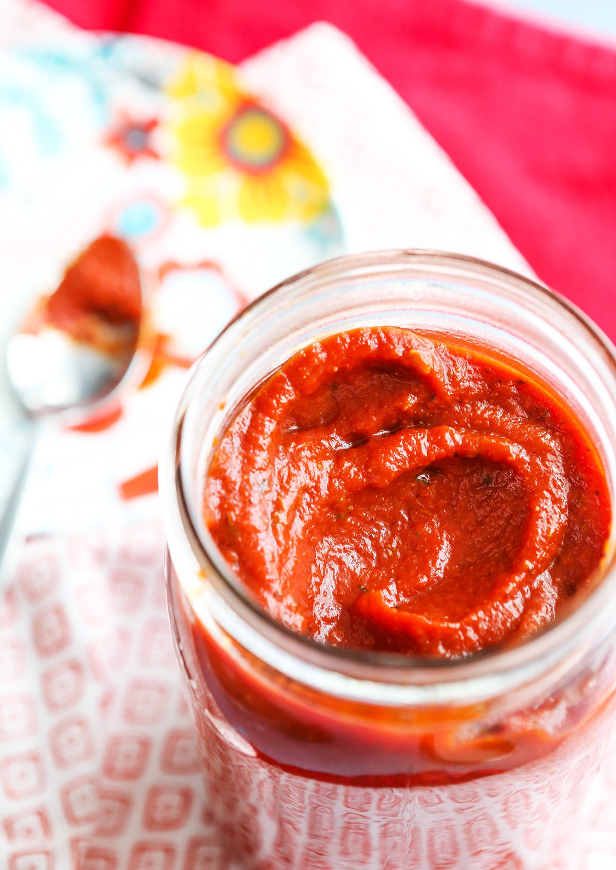 Mason jar filled with pizza sauce.
