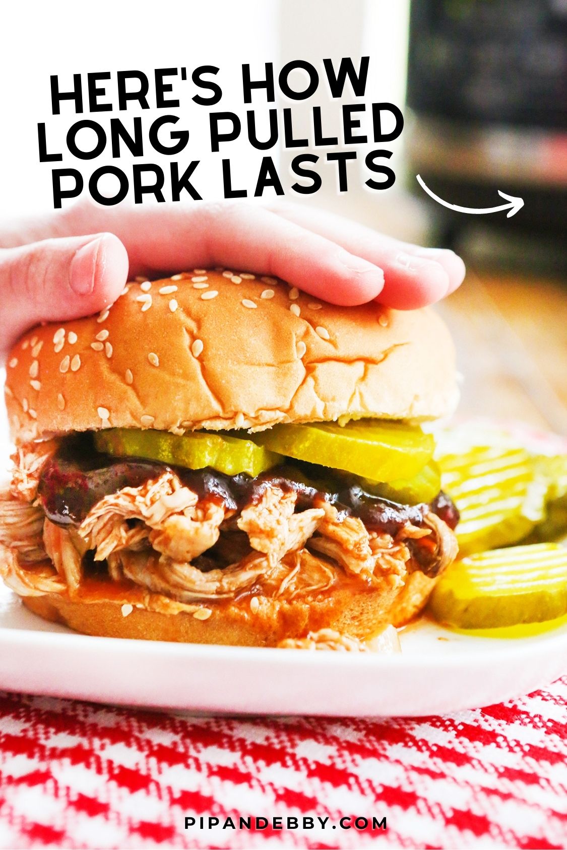 Photo of a pulled pork sandwich on a plate with text overlay reading, "Here's how long pulled pork lasts."