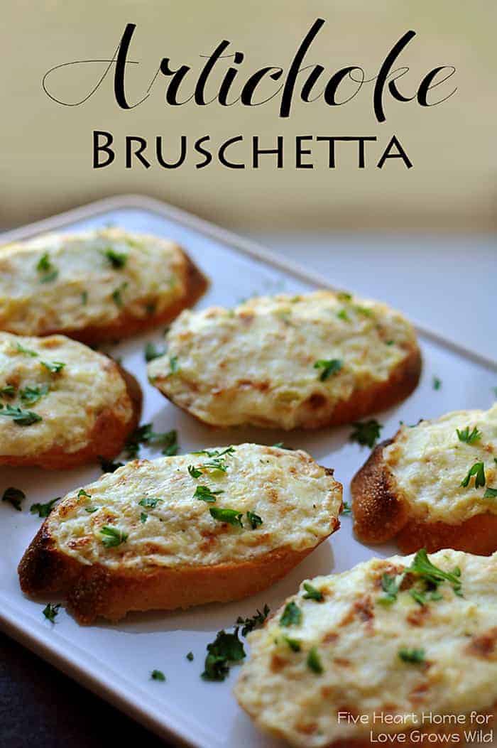 Artichoke bruschetta slices on a baking sheet. 