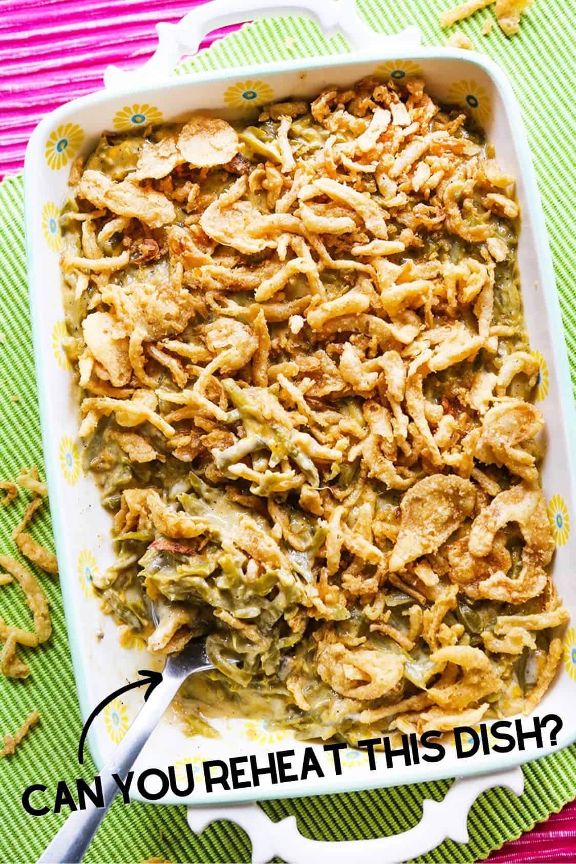 Top view of green bean casserole with text overlay reading, "Can you reheat this dish?"