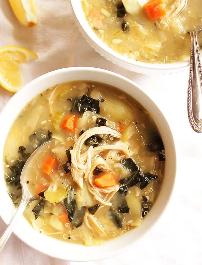 Spoon resting in a bowl of lemon artichoke soup. 