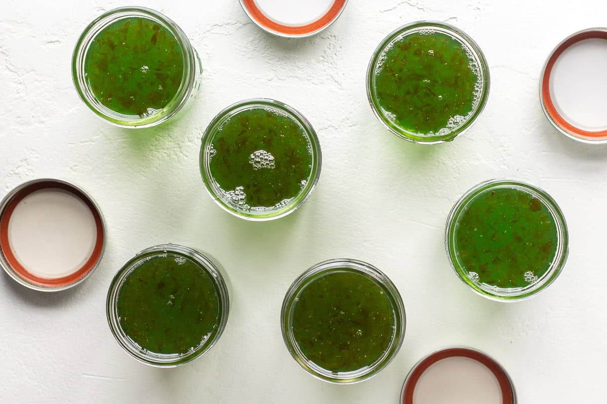 Fresh green pepper jelly in glass jars for recipes and snacks.