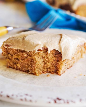 Close-up of a banana bar with frosting on a plate.