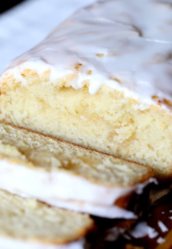 Lemon curd poundcake topped with glaze with a slice removed. 