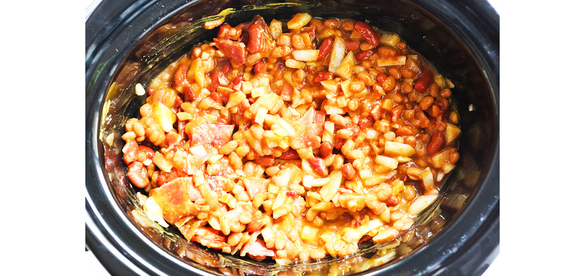 Cooked baked beans in a crockpot.