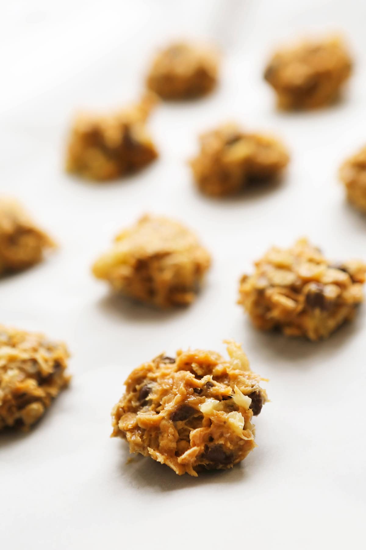 Close-up of no-egg peanut butter cookies on white surface.