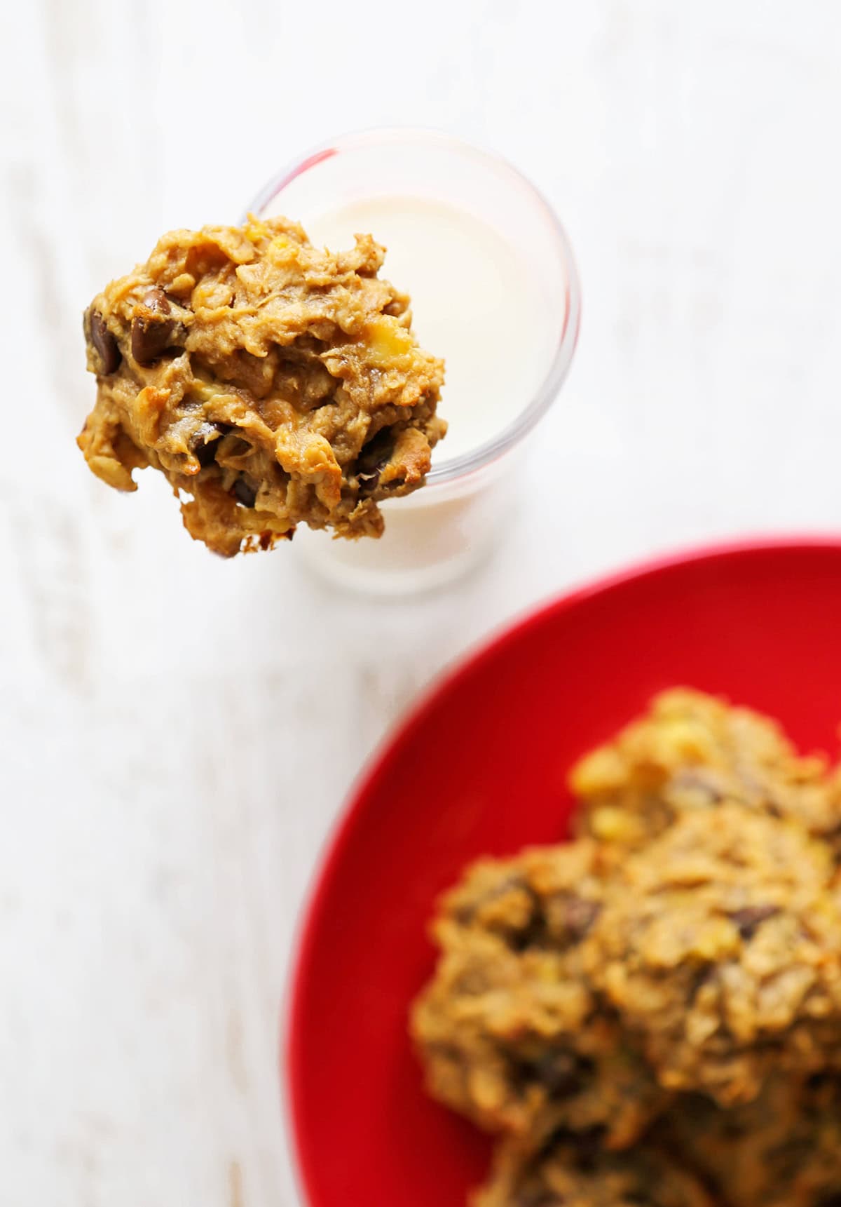 Chocolate chip peanut butter cookie with a glass of milk.