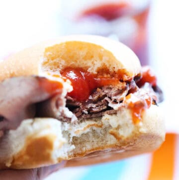 Close-up of a sandwich with shredded meat, sauce, and bun for copycat Arbys recipe.
