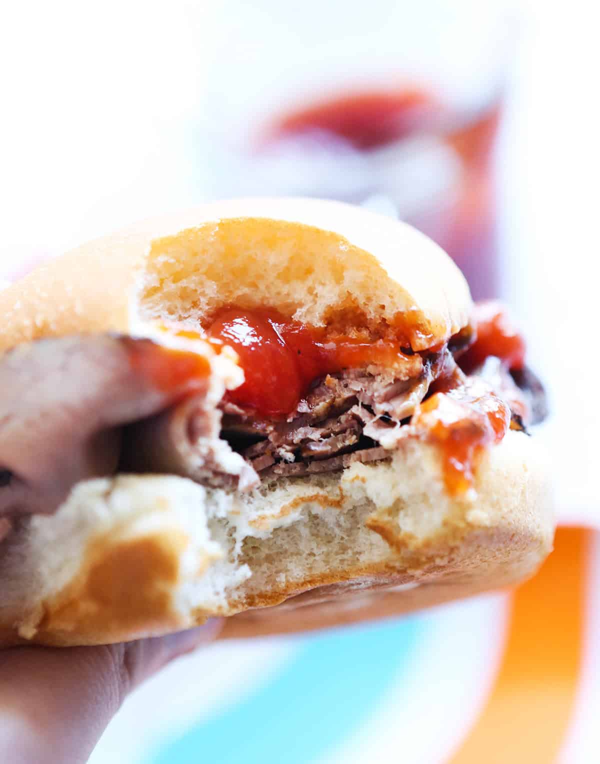 Close-up of a sandwich with shredded meat, sauce, and bun for copycat Arbys recipe.
