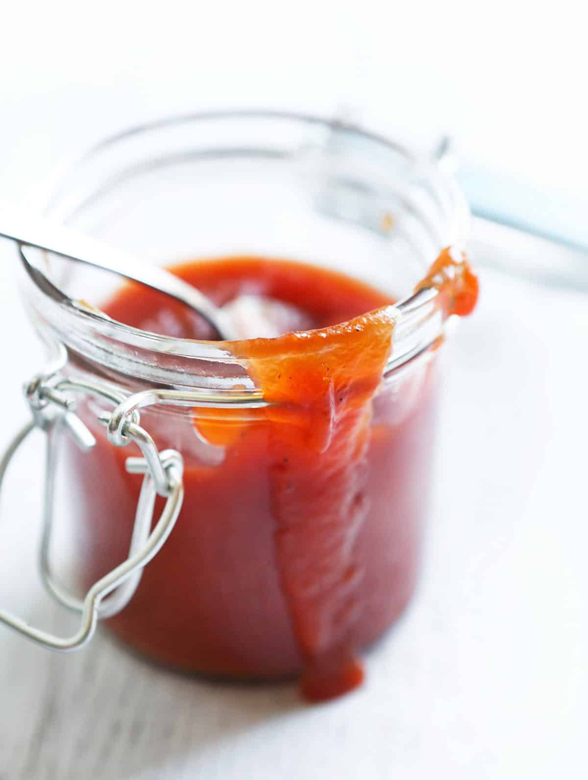 Close-up of a jar of homemade Arbys-style sauce with a spoon.