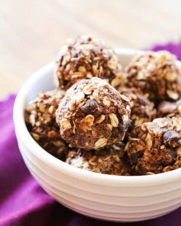 Delicious homemade snack bites with oats, chocolate chips, and nuts in a white bowl.