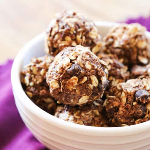 Delicious homemade snack bites with oats, chocolate chips, and nuts in a white bowl.