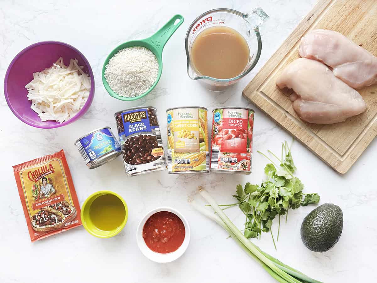 Fresh chicken, avocado, and ingredients for a delicious meal.