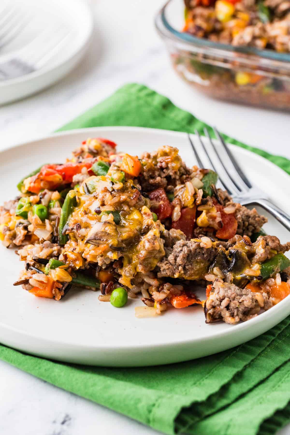 Serving of wild rice veggie ground beef casserole on a plate.