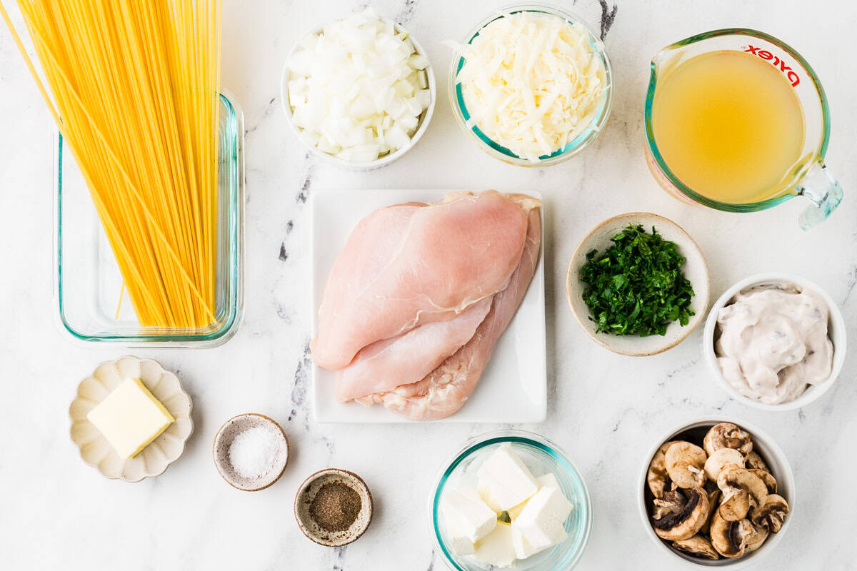 Ingredients for Instant Pot chicken tetrazzini in individual bowls, lined up on a white counter.