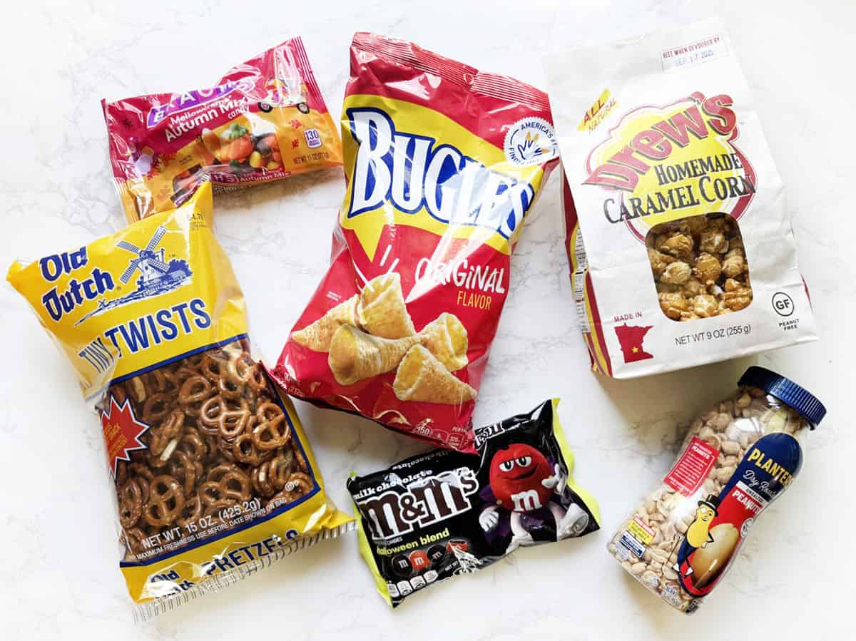Assorted snack bags including pretzels, caramel corn, and candy for Halloween.