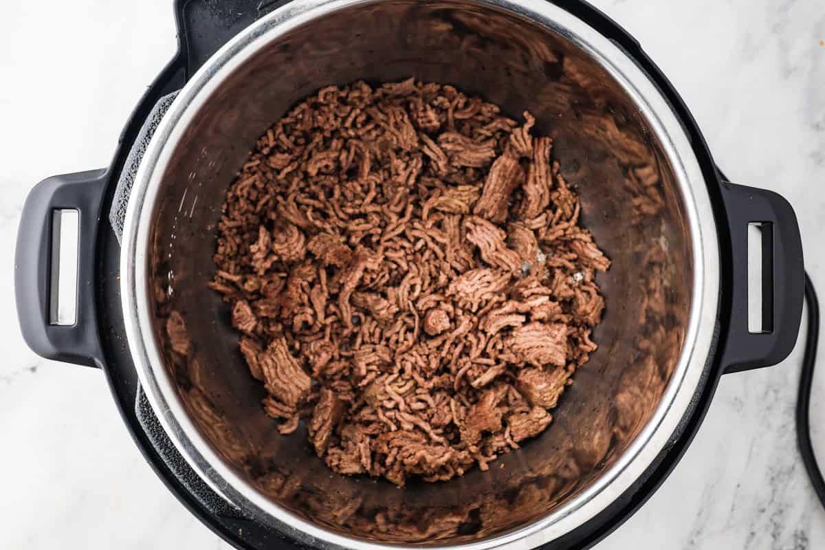 Instant Pot filled with cooked ground beef.
