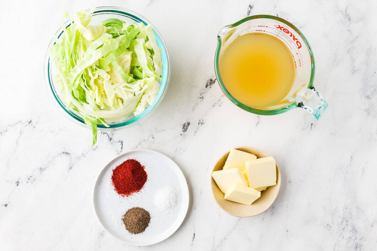 Ingredients for Instant Pot cabbage on a white counter.