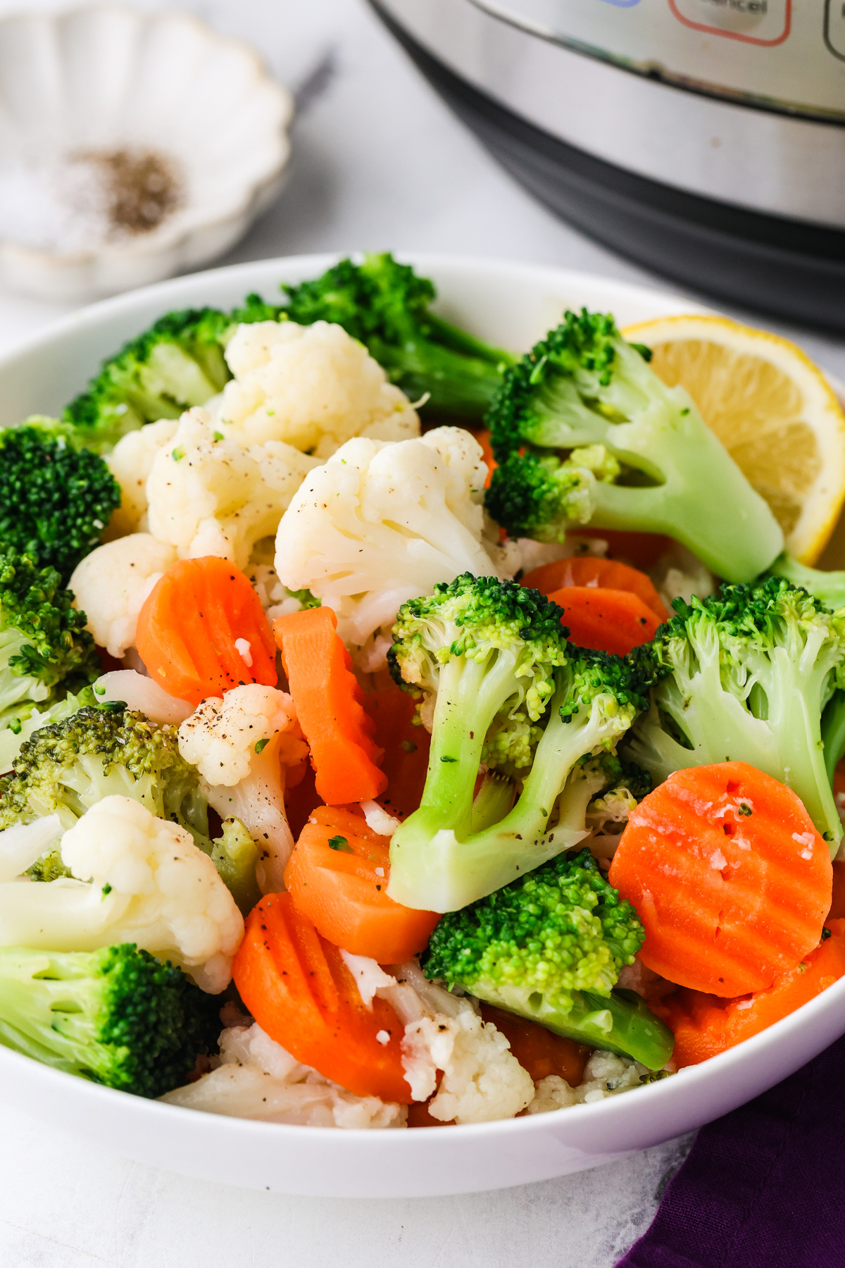 Healthy frozen broccoli, cauliflower, and carrots ready for Instant Pot cooking.