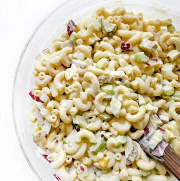 Creamy macaroni salad with chopped vegetables, perfect for picnics and summer meals.