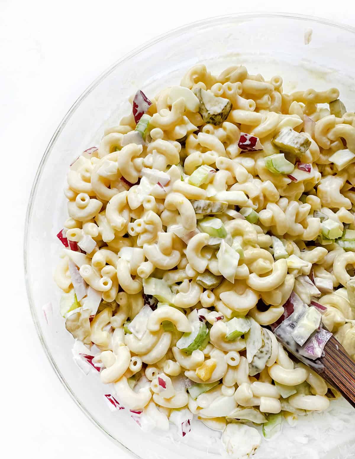 Creamy macaroni salad with chopped vegetables, perfect for picnics and summer meals.