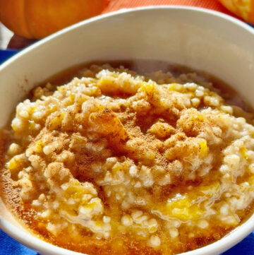 Creamy pumpkin oatmeal topped with cinnamon in a white bowl.